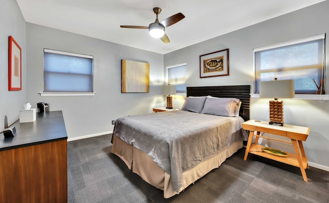 bedroom with dark colored carpet and ceiling fan