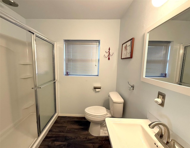 bathroom with toilet, sink, wood-type flooring, and walk in shower