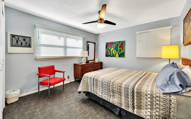 bedroom with ceiling fan and dark colored carpet