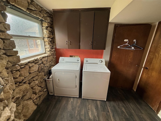 clothes washing area with cabinets, dark hardwood / wood-style flooring, and washer and clothes dryer