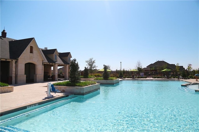 view of swimming pool with a patio area