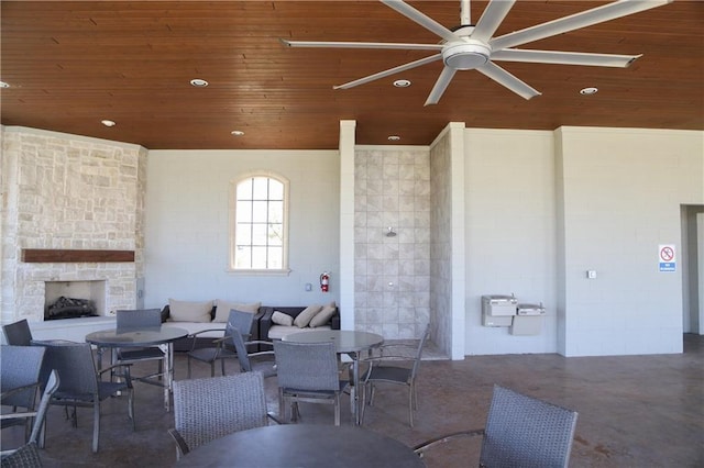 view of patio / terrace with ceiling fan and an outdoor stone fireplace