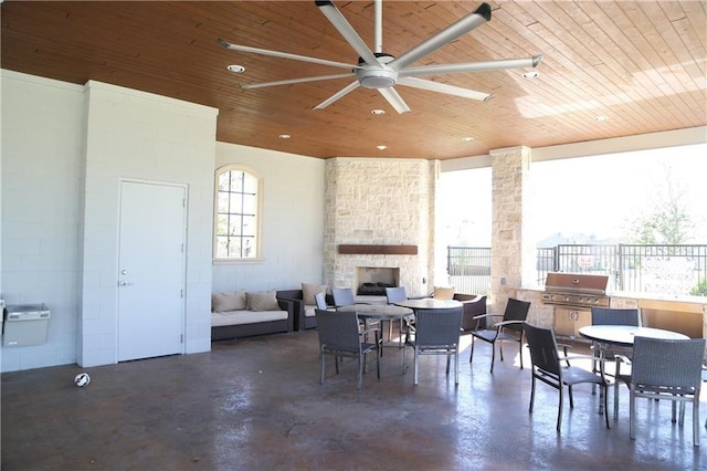 view of patio / terrace with a grill, ceiling fan, and a fireplace