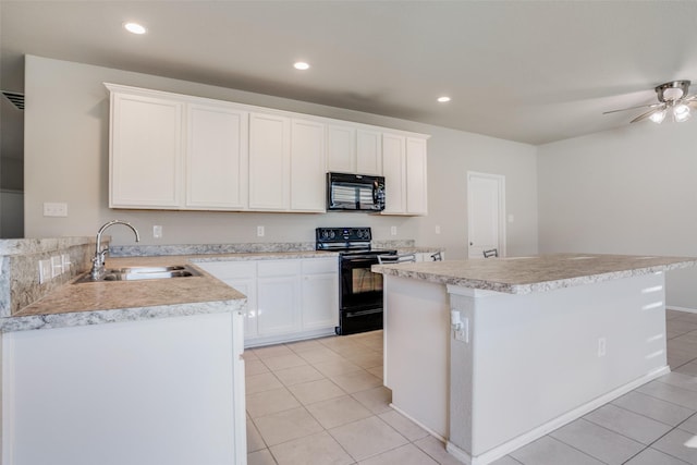 kitchen with white cabinetry, sink, light tile patterned floors, a kitchen island, and black appliances