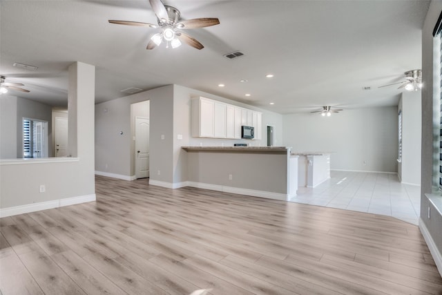 unfurnished living room with light hardwood / wood-style flooring