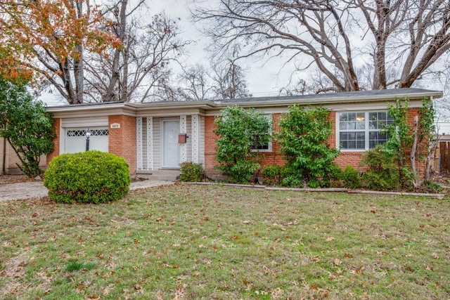 single story home with a front yard and a garage