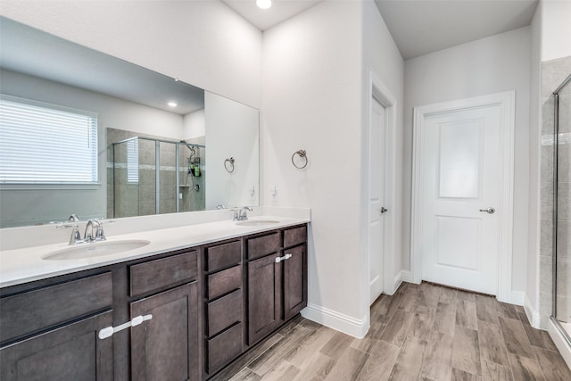 bathroom featuring vanity and a shower with shower door