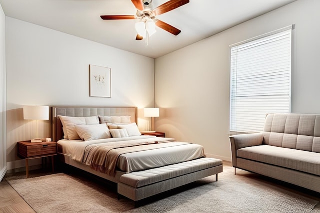 bedroom with ceiling fan and multiple windows