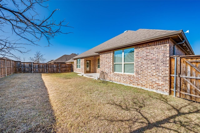 rear view of property with a patio and a lawn