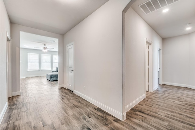 hall with hardwood / wood-style flooring