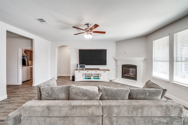 living room featuring hardwood / wood-style floors and ceiling fan