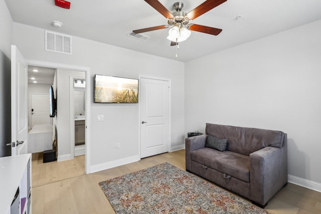 sitting room with ceiling fan and light hardwood / wood-style floors