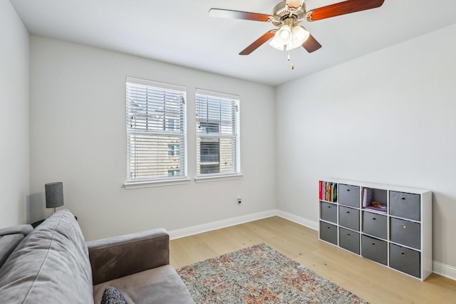 sitting room with ceiling fan and light hardwood / wood-style floors