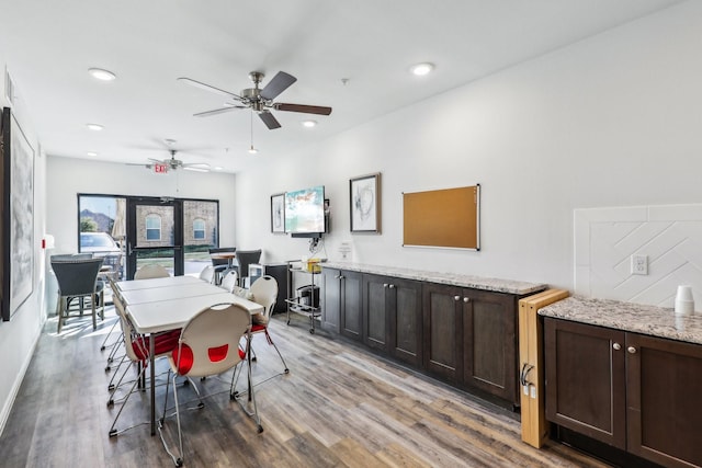 dining room with ceiling fan and wood-type flooring