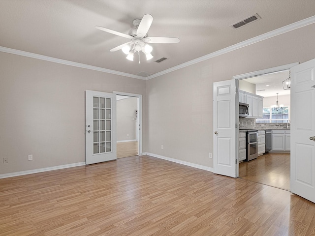 interior space with a textured ceiling, ceiling fan with notable chandelier, crown molding, and light hardwood / wood-style flooring