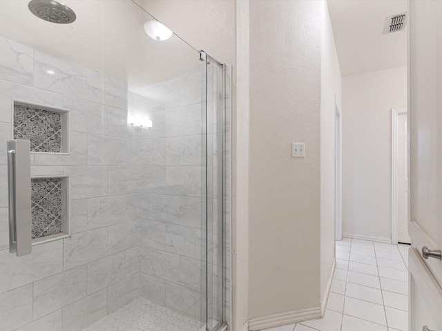 bathroom with tile patterned flooring and a shower with door