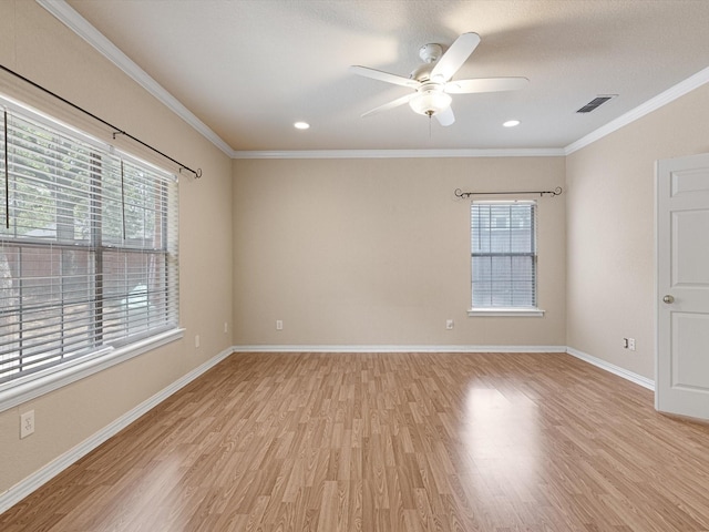 empty room featuring ceiling fan, light hardwood / wood-style flooring, and crown molding