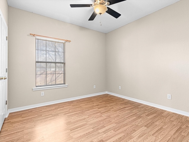 spare room with light wood-type flooring and ceiling fan