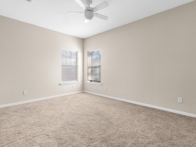 spare room featuring ceiling fan and carpet flooring