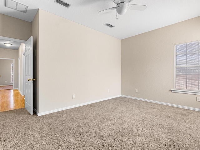 unfurnished room with carpet flooring and ceiling fan