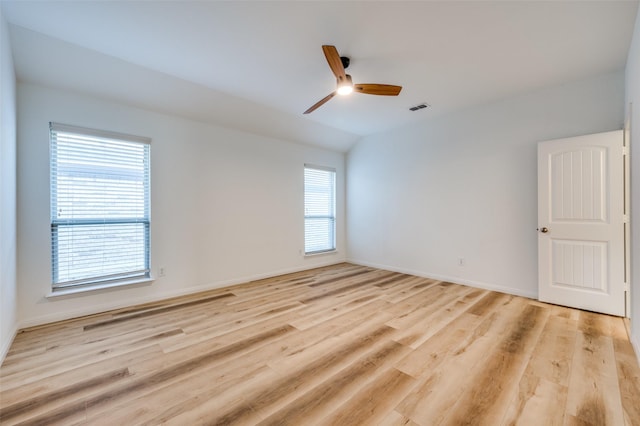 unfurnished room with ceiling fan, vaulted ceiling, and light hardwood / wood-style flooring