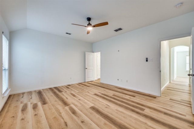 empty room featuring ceiling fan, lofted ceiling, and light wood-type flooring