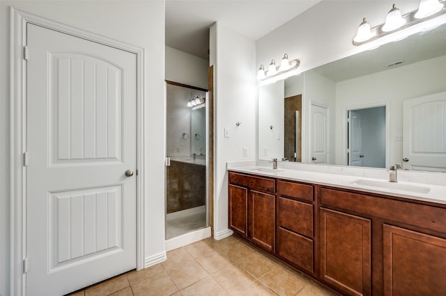 bathroom featuring tile patterned flooring, vanity, and walk in shower