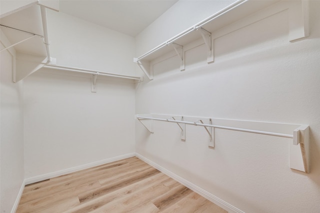 walk in closet featuring hardwood / wood-style flooring