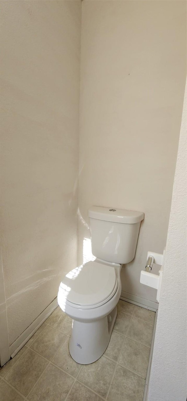 bathroom featuring tile patterned flooring and toilet