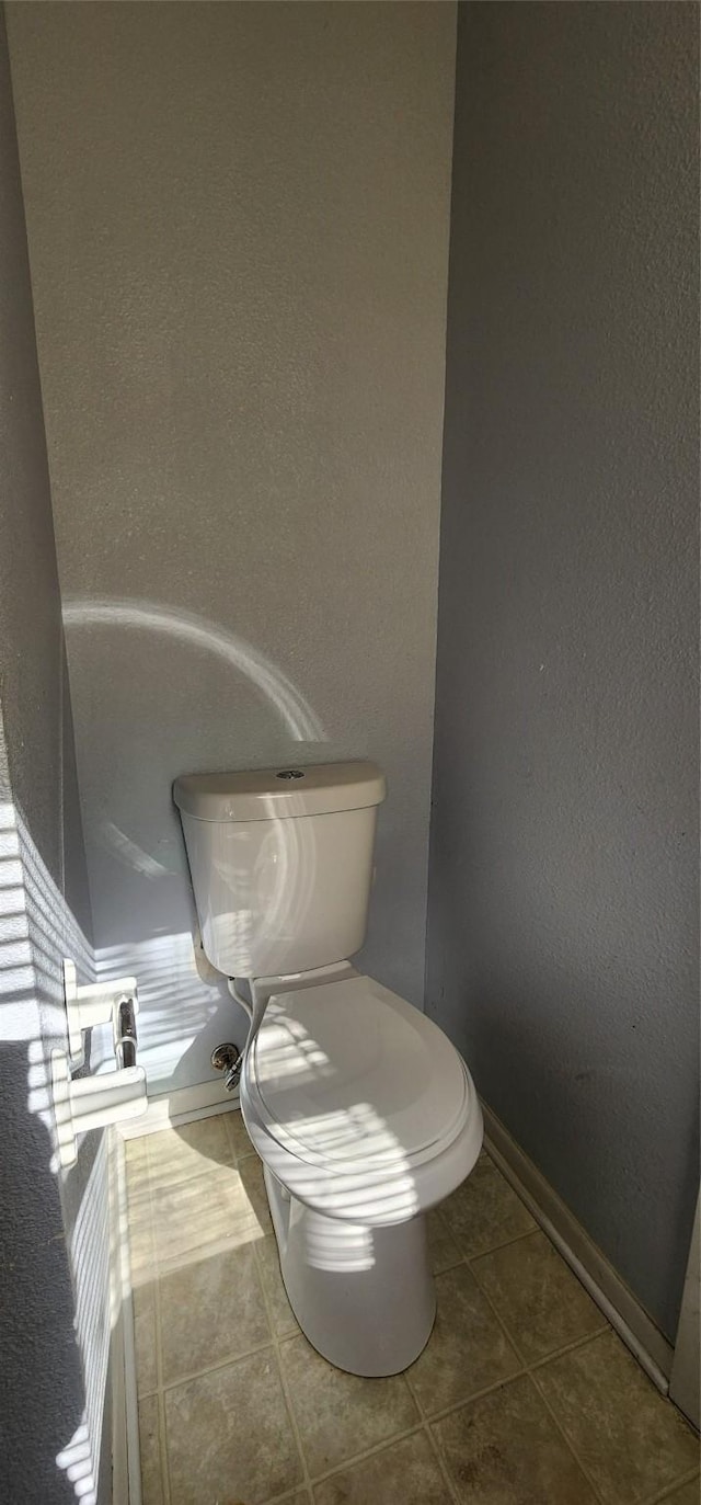 bathroom featuring tile patterned floors and toilet