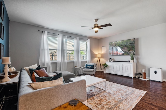 living room featuring dark hardwood / wood-style flooring and ceiling fan