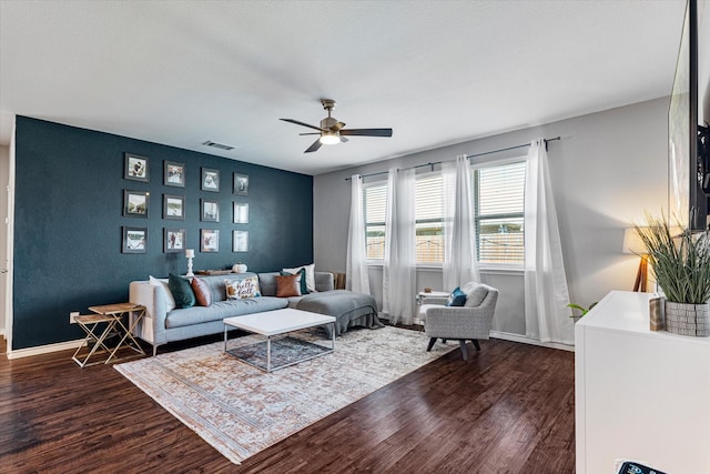 living room with dark hardwood / wood-style floors and ceiling fan