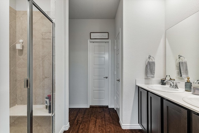 bathroom featuring vanity, a shower with shower door, and hardwood / wood-style floors