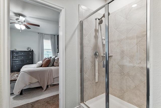 bathroom featuring a shower with door and ceiling fan