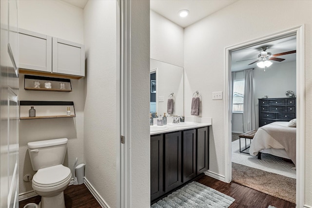 bathroom featuring vanity, ceiling fan, wood-type flooring, and toilet