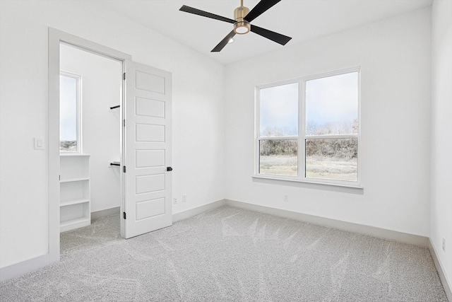 unfurnished bedroom with light colored carpet and ceiling fan