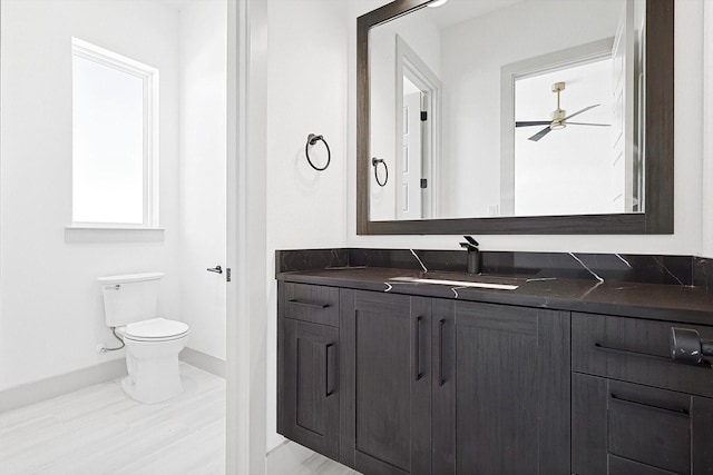 bathroom featuring vanity, ceiling fan, and toilet