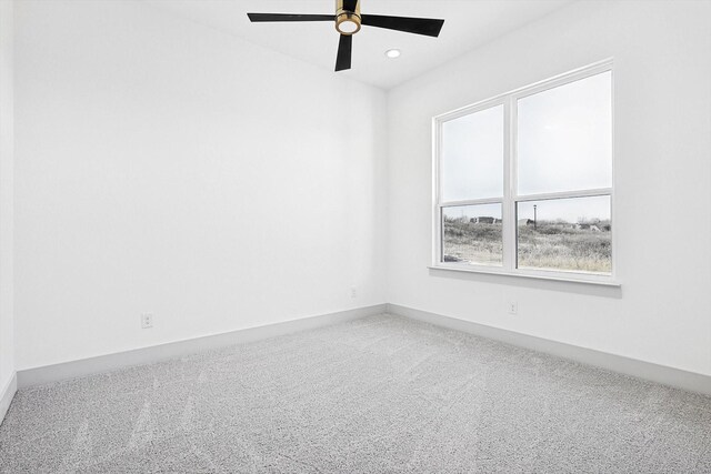 spare room with carpet floors and ceiling fan