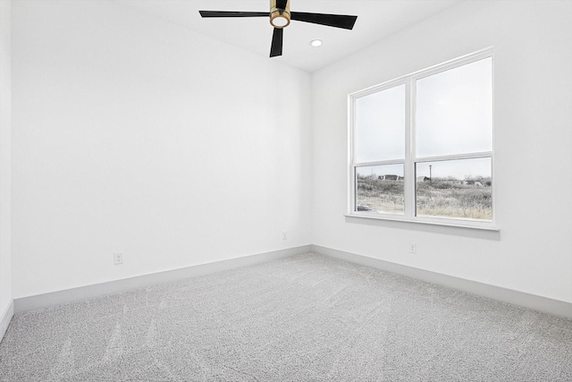 carpeted empty room featuring ceiling fan