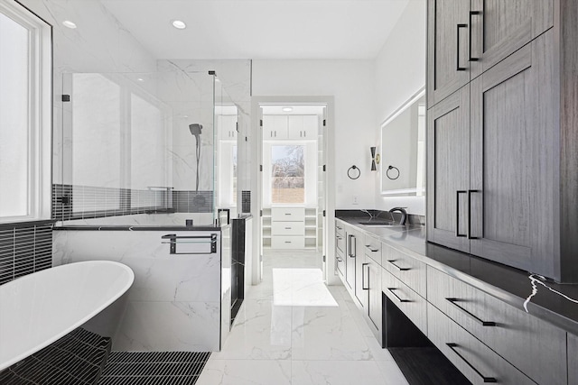 bathroom featuring vanity and independent shower and bath