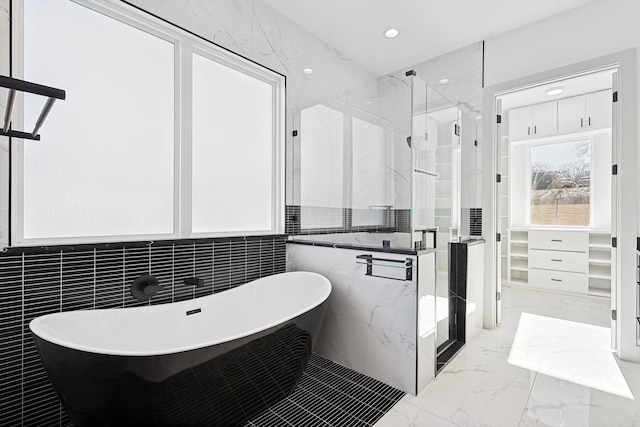 bathroom featuring tile walls and plus walk in shower