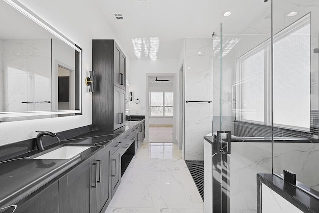 bathroom with vanity, ceiling fan, and a shower with shower door