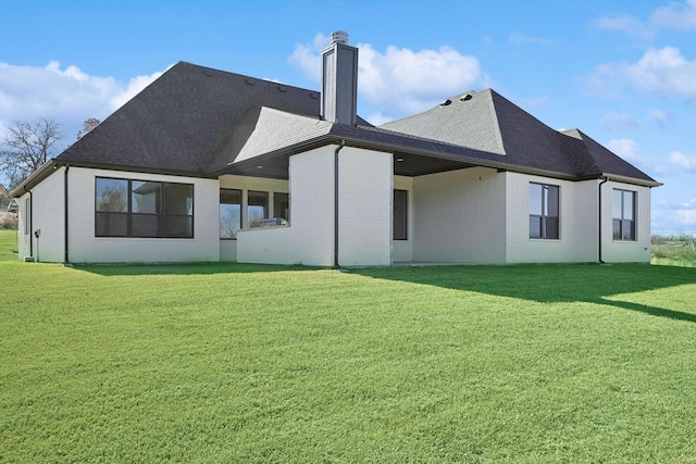 rear view of house with a lawn