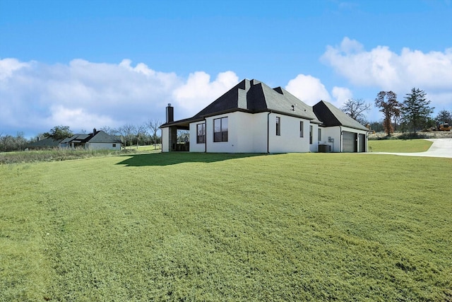 view of property exterior with a yard, a garage, and central air condition unit