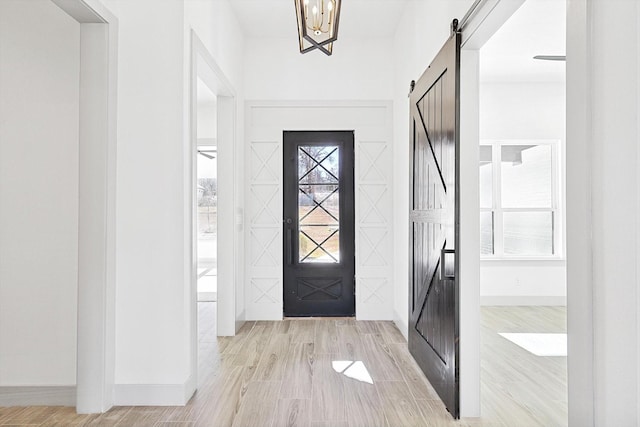 entrance foyer featuring a barn door and light wood-type flooring