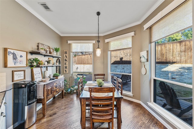 dining room with crown molding and dark hardwood / wood-style floors