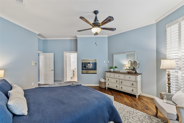 bedroom featuring ornamental molding, ceiling fan, and dark hardwood / wood-style flooring