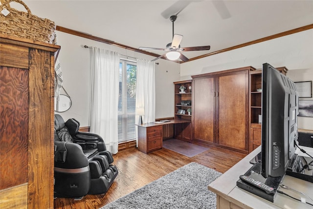 office with ceiling fan, crown molding, and light wood-type flooring