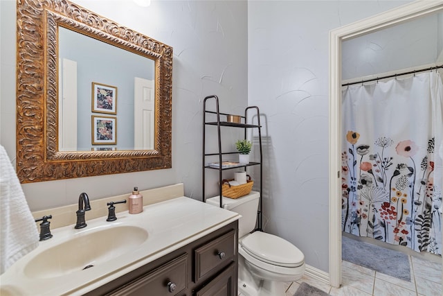 bathroom with tile patterned floors, vanity, toilet, and curtained shower