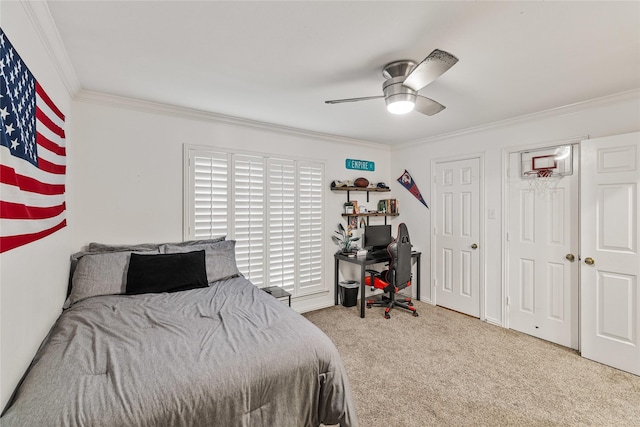 carpeted bedroom featuring ceiling fan and ornamental molding